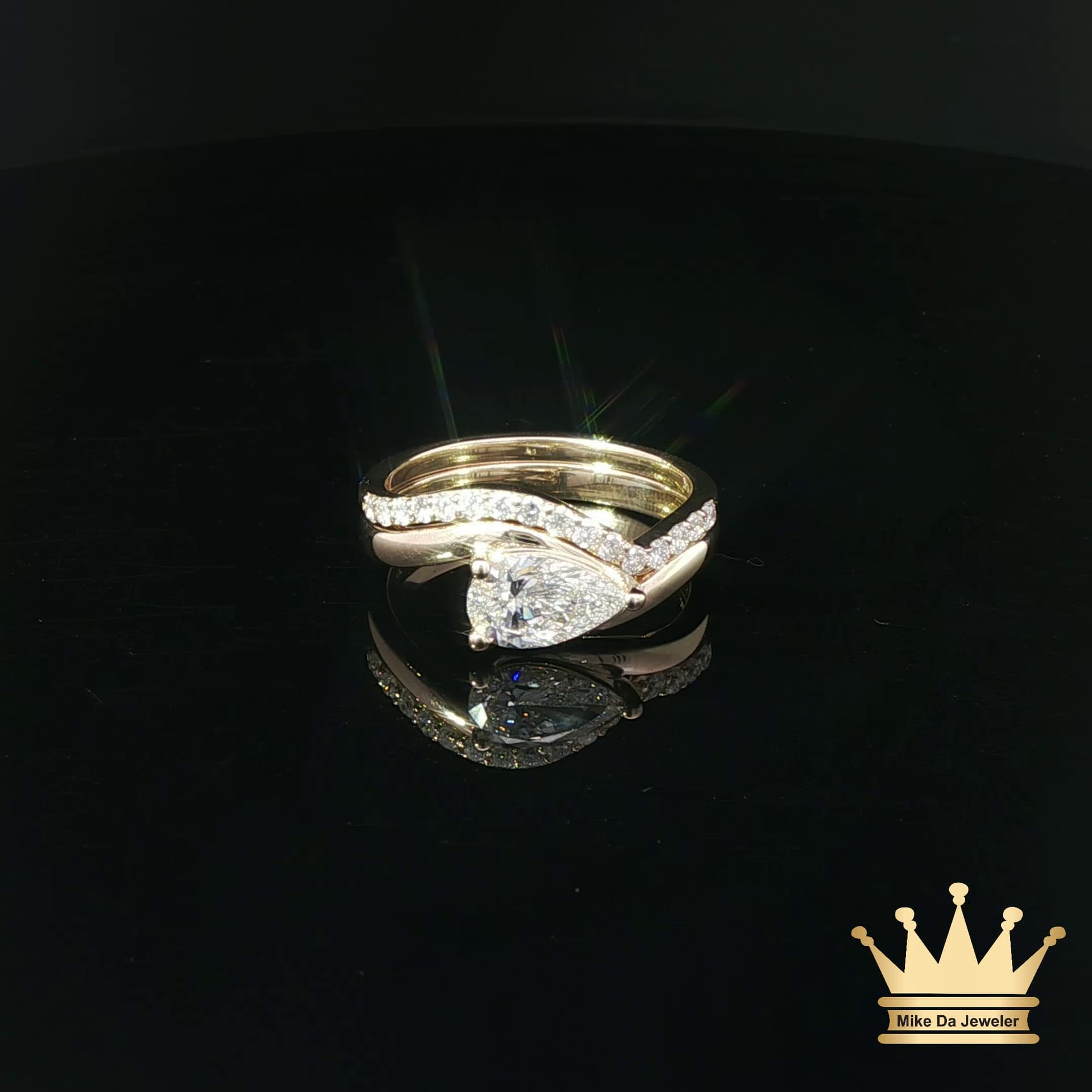 Pear-Shaped Diamond Bypass Engagement Ring and Contoured Diamond Band Set in Yellow Gold